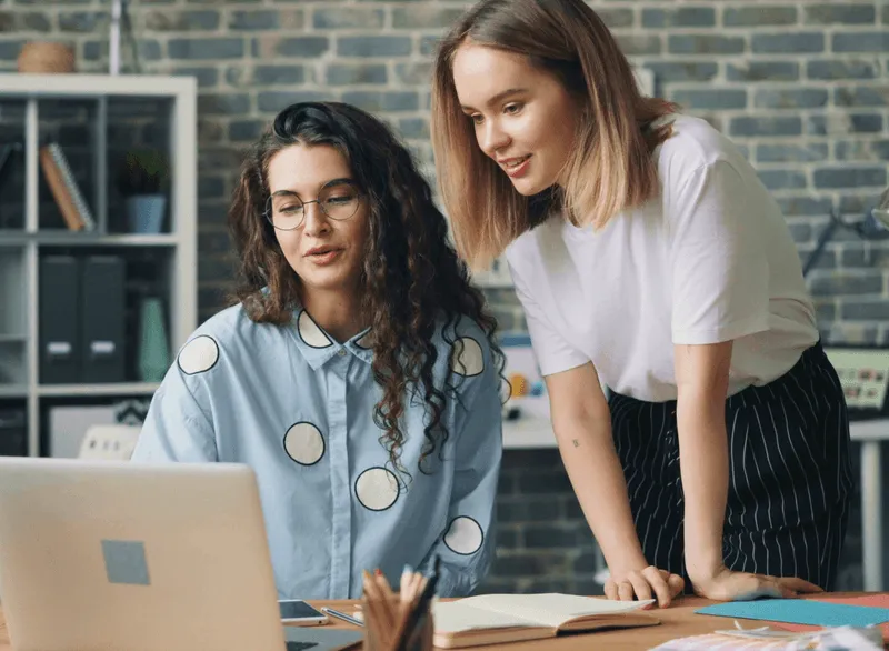 Co-workers working together on computer