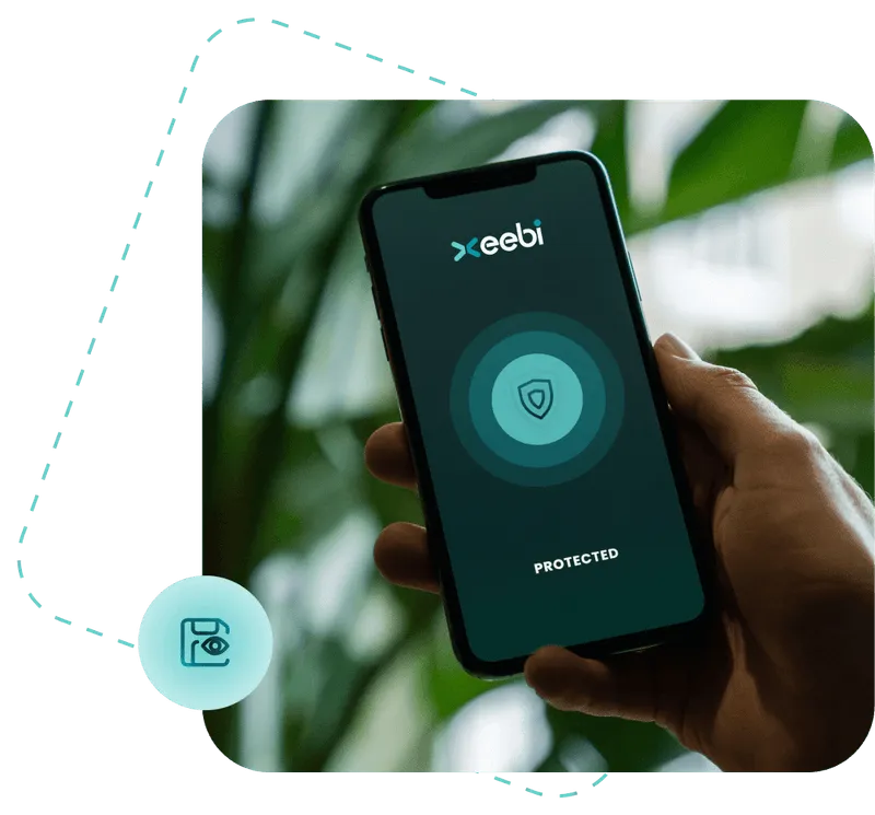 Hand holding a smartphone displaying the Xeebi app with a security shield icon and the word ‘Protected’ on screen, symbolizing mobile cybersecurity and two-factor authentication